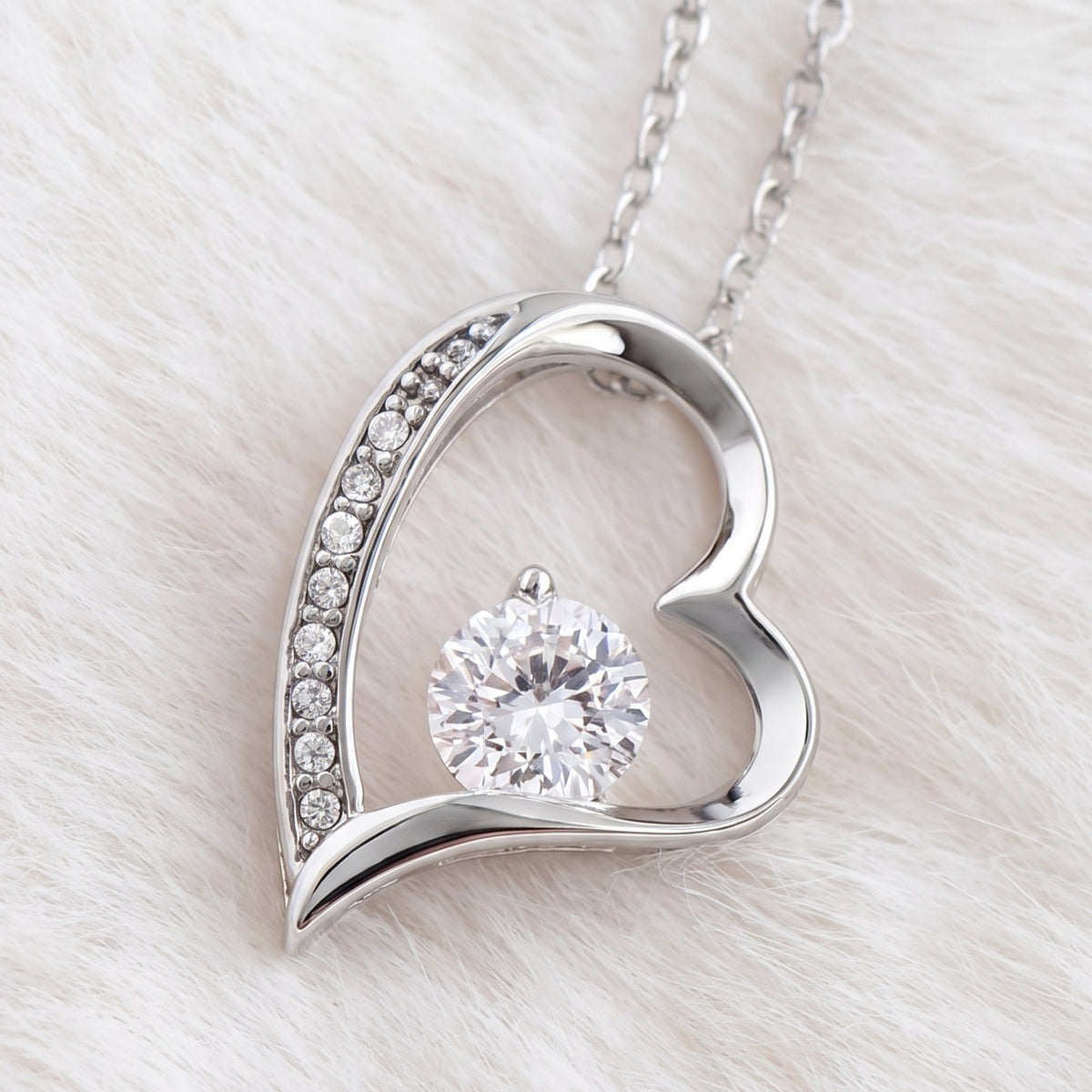 Close-up of the heart pendant with pavé crystals and a round-cut cubic zirconia