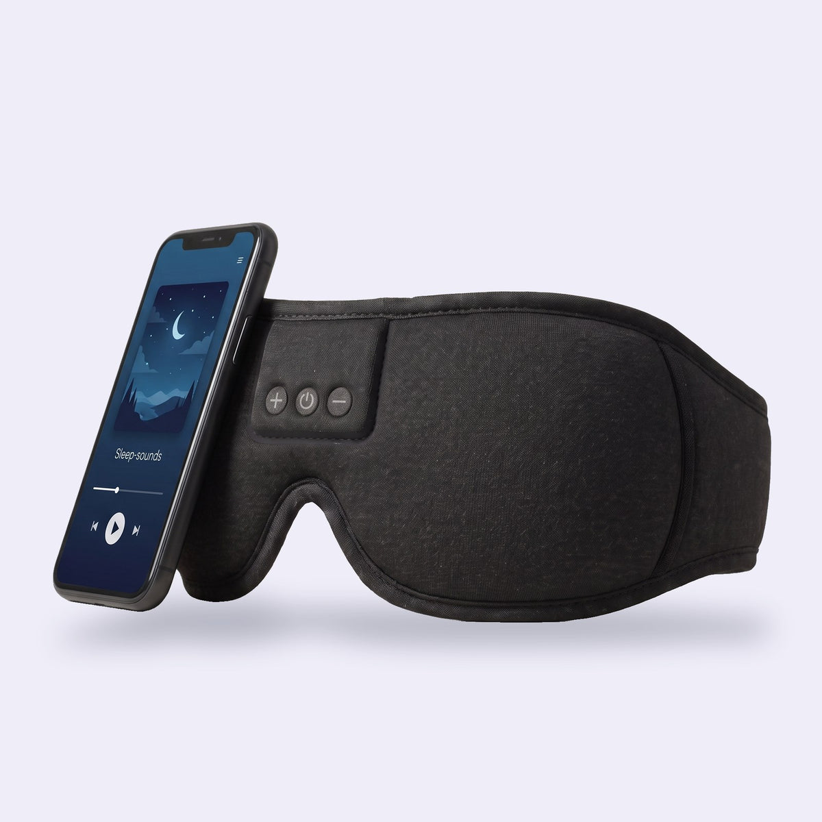 Hushband sleep headphones in black knit next to a phone playing sleep sounds