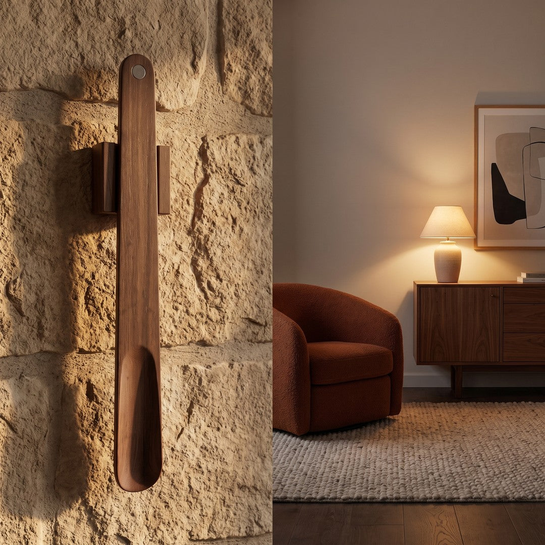 The wooden shoehorn on a textured wall next to a warm living room