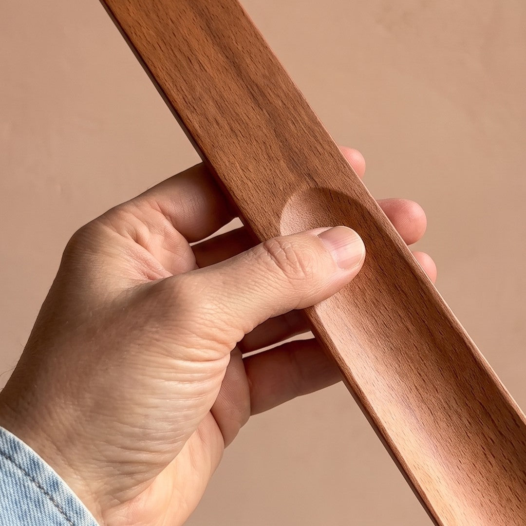Solid beechwood shoehorn with thumb dent and curved tip