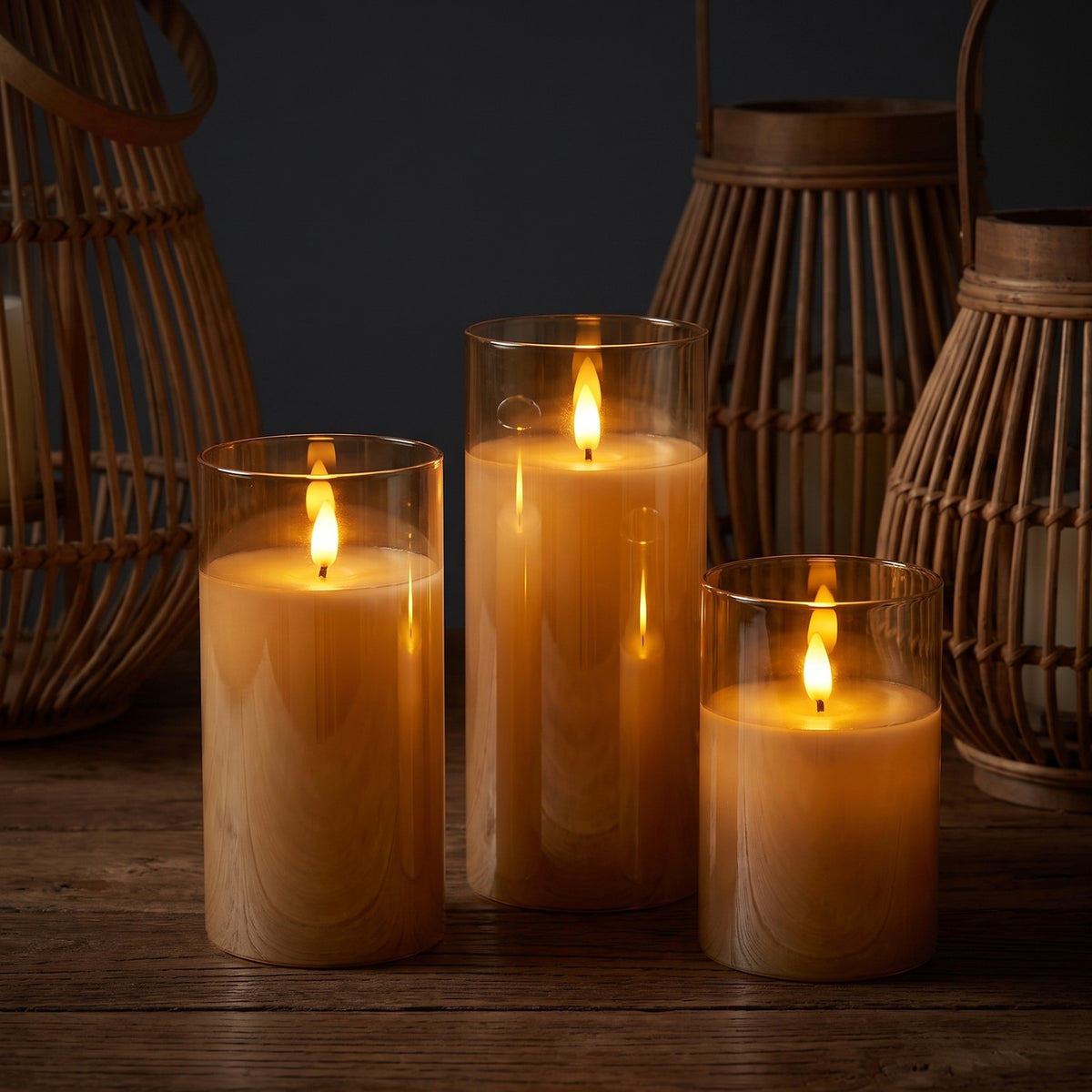 Amber VEKE candles glowing in a dark room with rattan lanterns