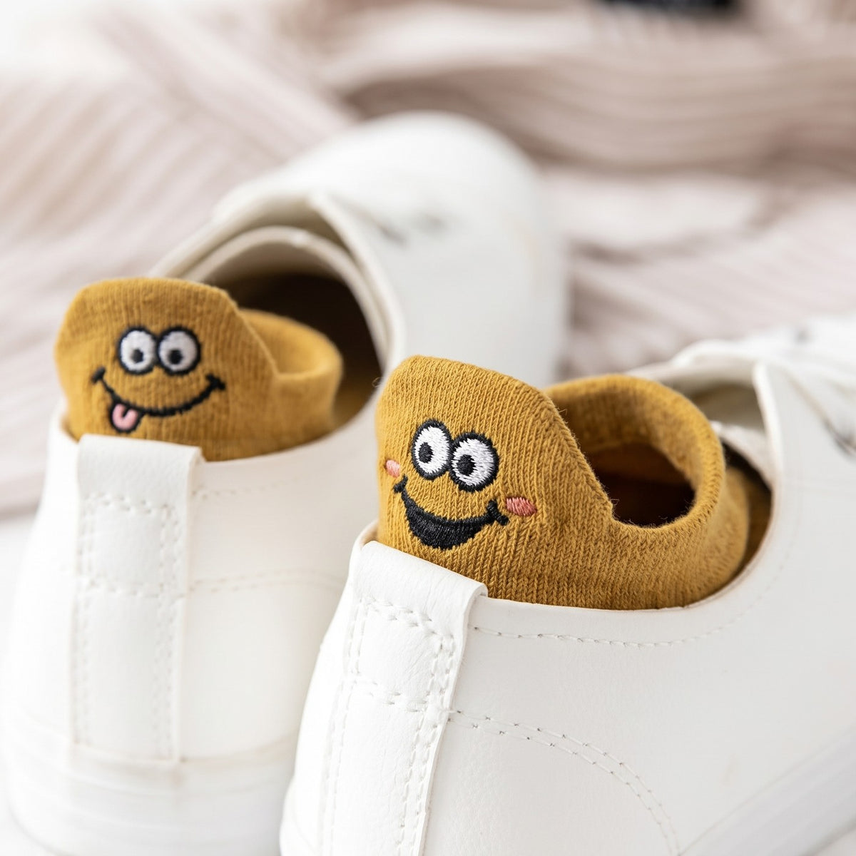 Mustard TASSA socks peeking over the heel of white sneakers