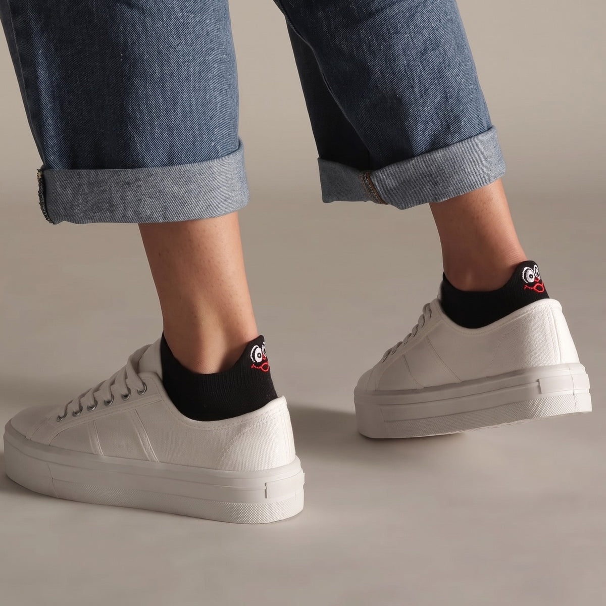 Black TASSA socks with rolled jeans and white platform sneakers