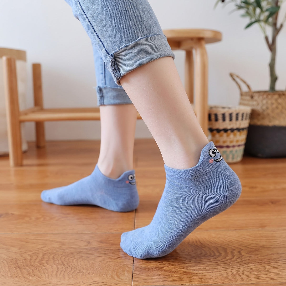 Cornflower-blue TASSA socks on a wooden floor