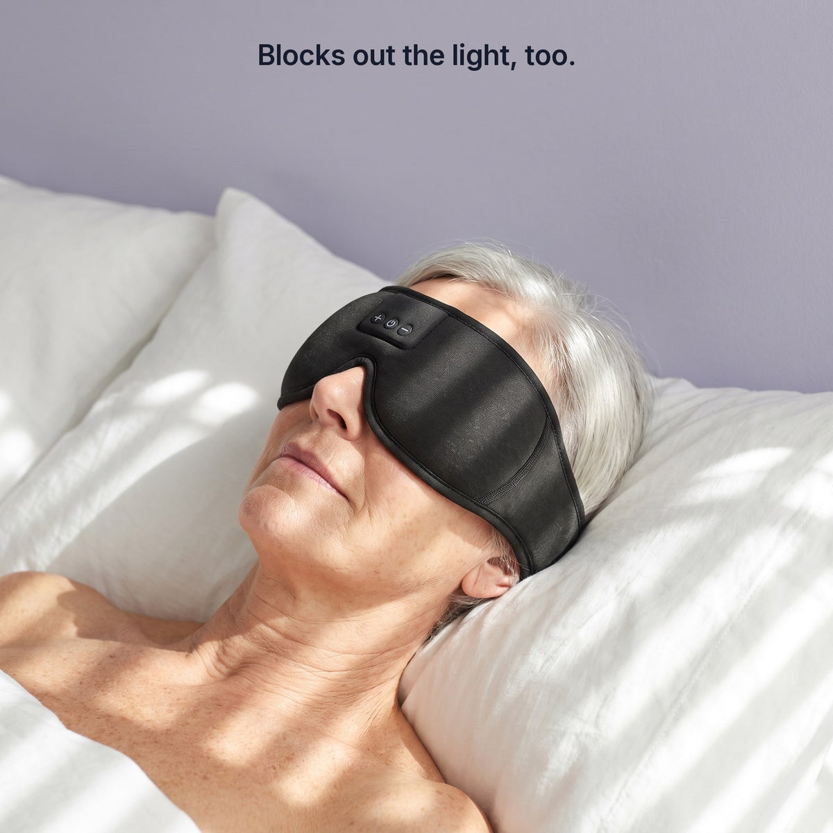 A woman sleeping in morning sunlight wearing the black knit Hushband