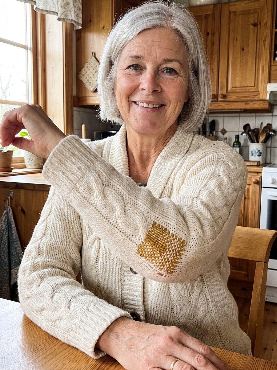 A woman showing a woven patch on her cardigan sleeve