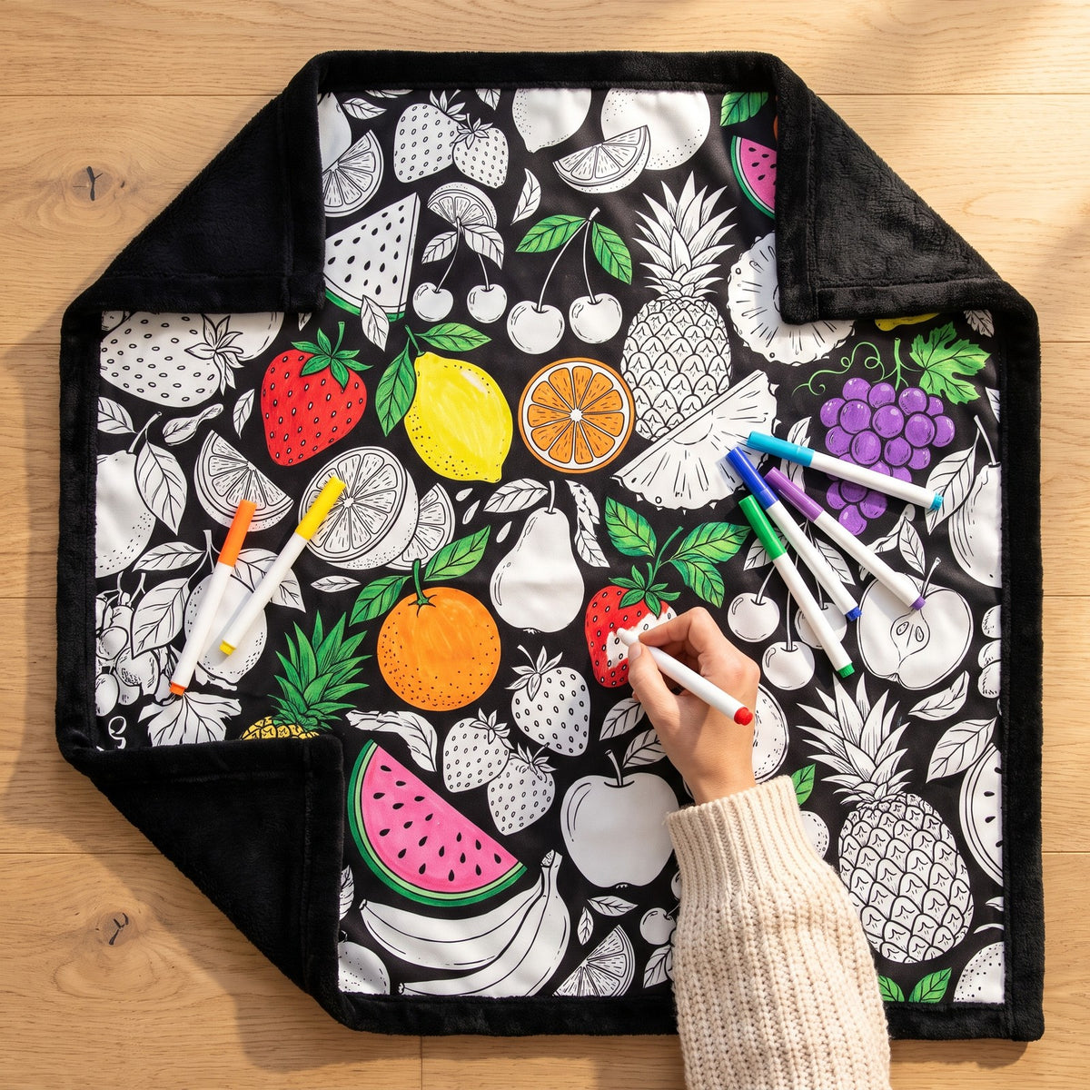 Colouring in the Fruits blanket with washable markers