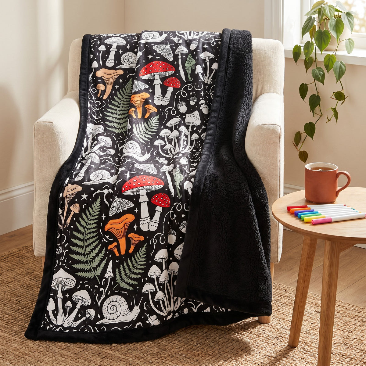 The Mushroom Magic blanket over an armchair