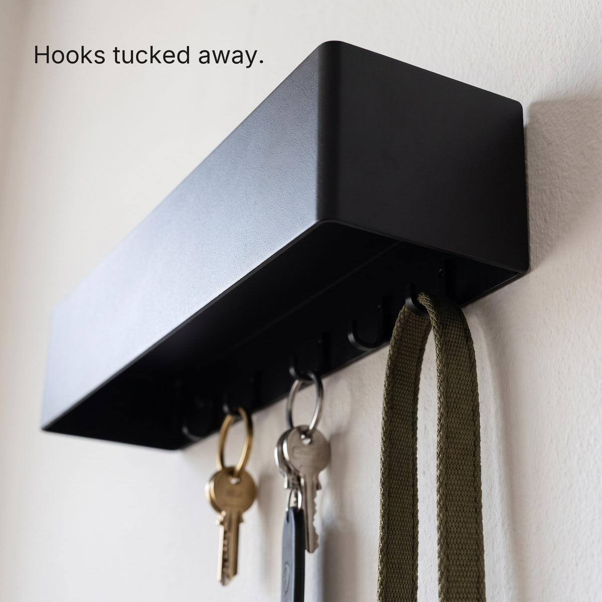 Six hidden hooks under the Key Shelf holding keys and a lead