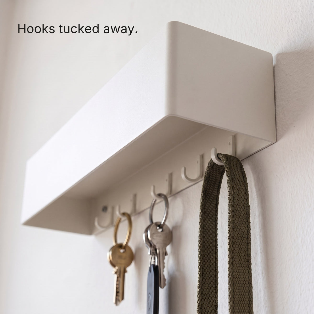 Six hidden hooks under the Key Shelf holding keys and a lead