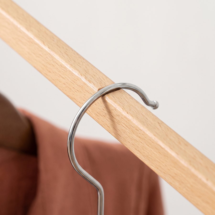 A hanger resting in a notch on a beechwood arm
