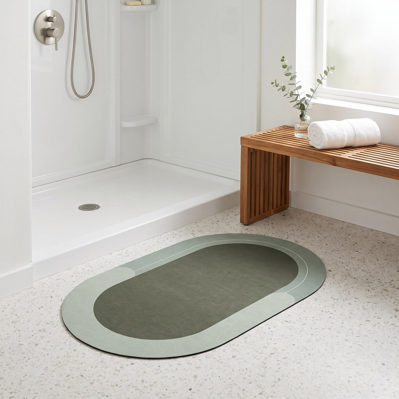 The Quick-Dry Mat in forest green in front of a walk-in shower